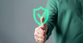 Green shield and tick emblem with thumbs up showing confident, safe cybersecurity policy