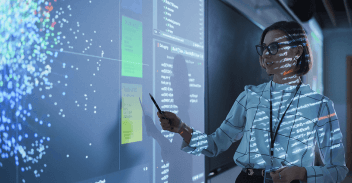 Technical speaker indicating data on large projected screen